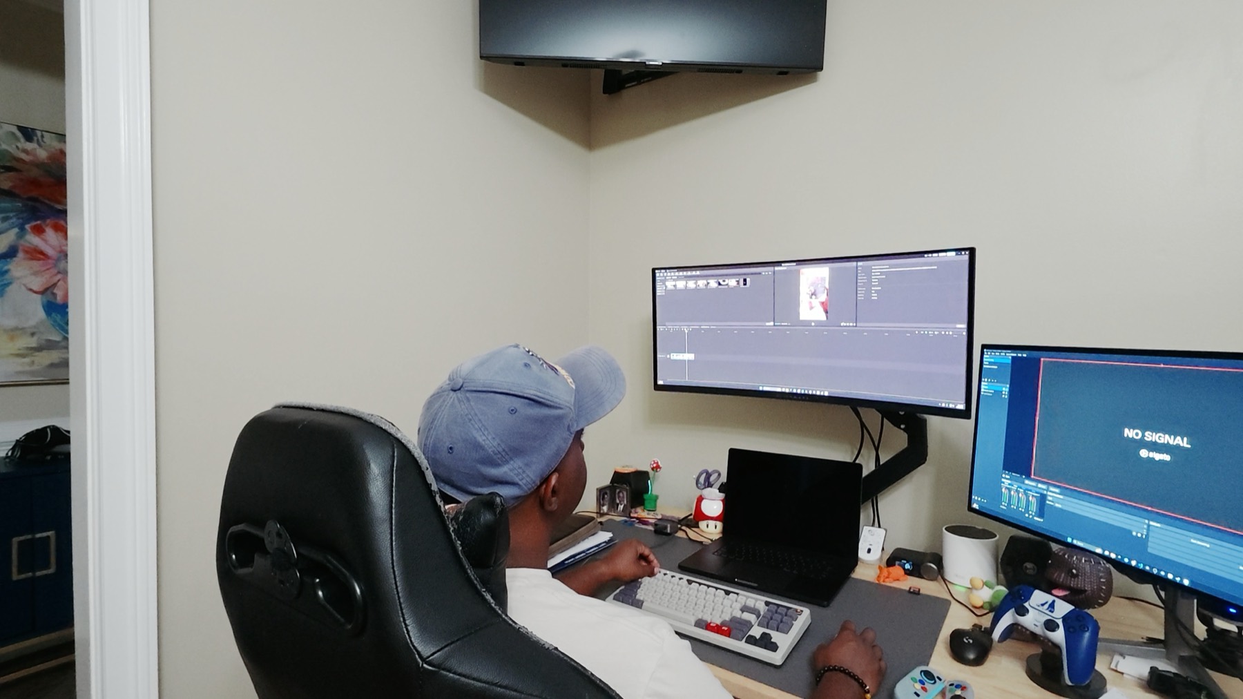 Chuck at his desk editing a video on an ultrawide monitor, second monitor showing the capture card feed