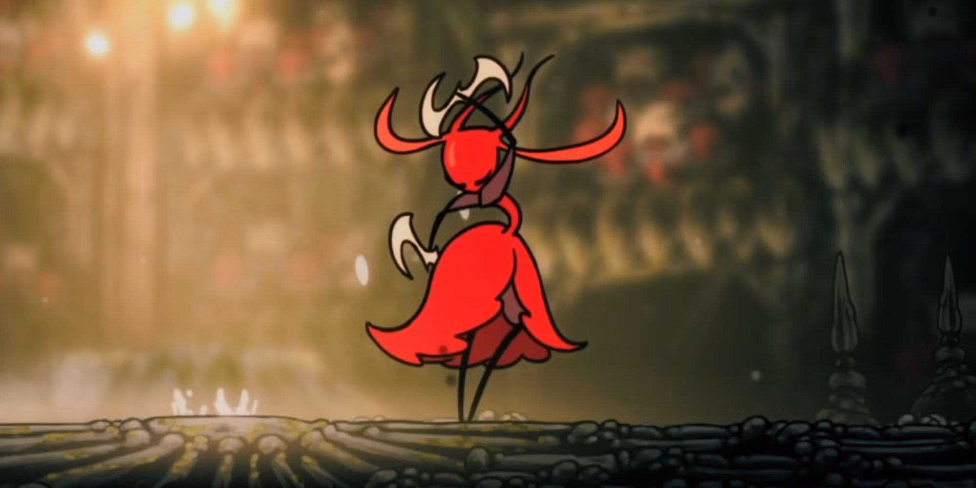 Skarrsinger Karmelita standing in her arena in Hollow Knight: Silksong, a red-cloaked figure with pale curved blades, backlit by the warm glow of the hall behind her